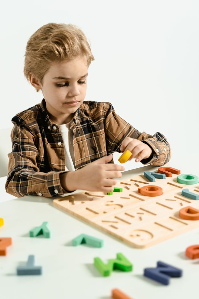 Young boy engaging with a colorful alphabet puzzle, fostering early education and play.